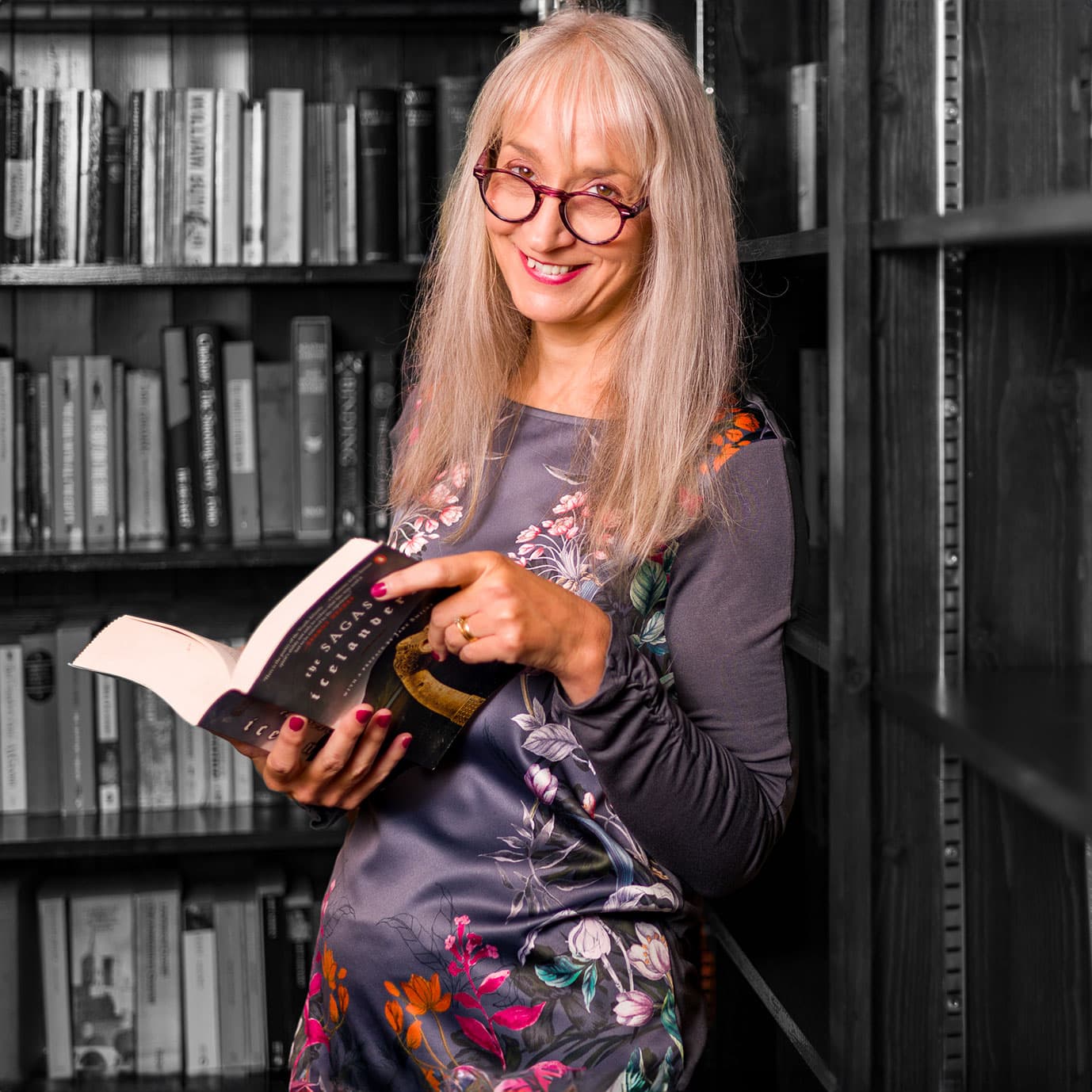 Melanie Cotton, proofreader and editor, gimlet-eyed grammar tickler® reading a book in her library